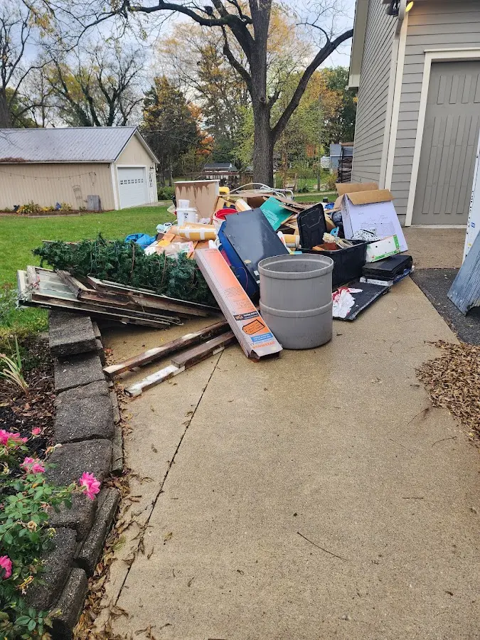 Dumpster being loaded with debris for Estate Cleanout Dumpster Rental in Springdale